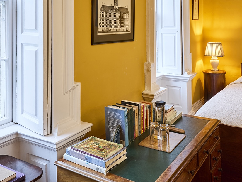 Roundwood House Roundwood House bedroom table with books